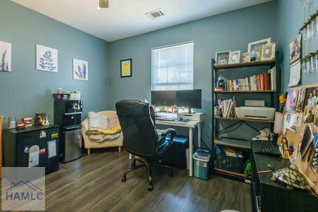 home office with ceiling fan and dark hardwood / wood-style flooring