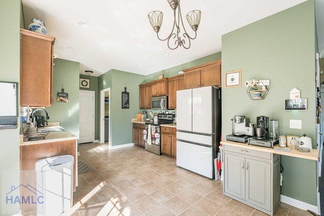 kitchen featuring pendant lighting, a chandelier, sink, and stainless steel appliances