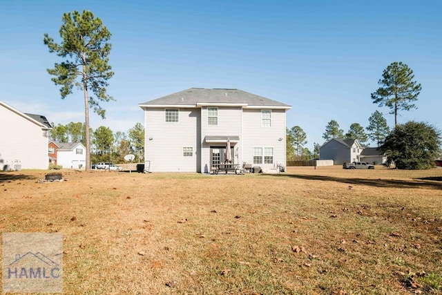 rear view of house with a yard and a patio