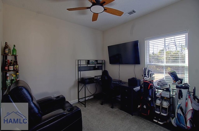 carpeted office featuring ceiling fan