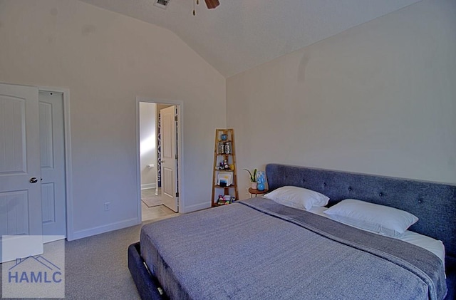 bedroom featuring connected bathroom, carpet floors, vaulted ceiling, and ceiling fan