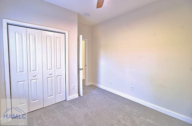 unfurnished bedroom with ceiling fan, carpet flooring, and a closet