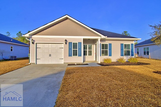 ranch-style home featuring a garage and central air condition unit