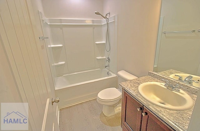 full bathroom featuring hardwood / wood-style flooring, shower / tub combination, vanity, and toilet