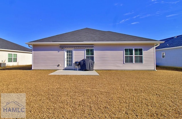 rear view of property with a patio, a yard, and cooling unit