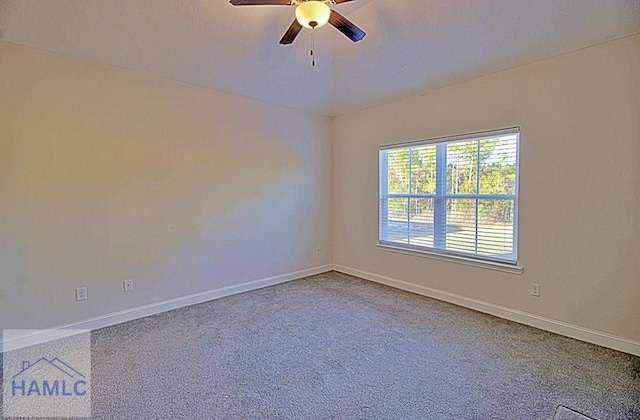 empty room featuring vaulted ceiling, ceiling fan, and carpet flooring