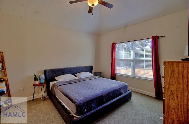 bedroom featuring ceiling fan, light colored carpet, and vaulted ceiling