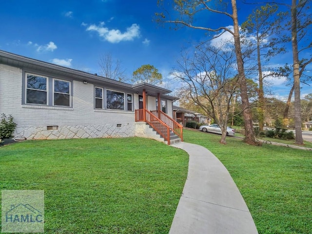 ranch-style house featuring brick siding, crawl space, and a front lawn