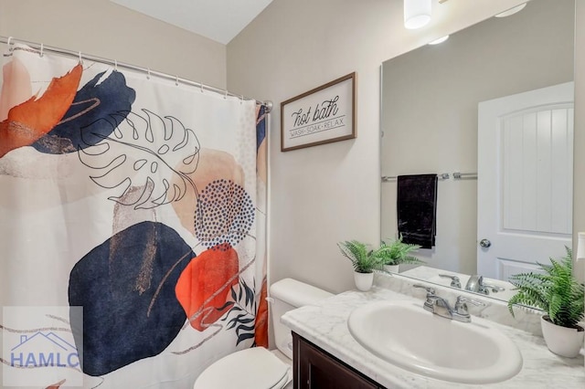 bathroom featuring vanity and toilet