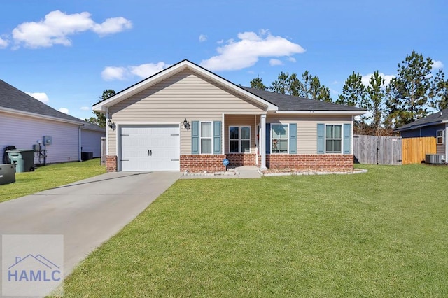 view of front of property featuring a garage, central air condition unit, and a front yard