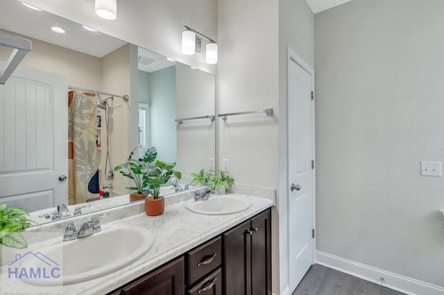 bathroom featuring a shower with shower curtain, wood-type flooring, and vanity