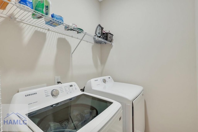 clothes washing area featuring separate washer and dryer