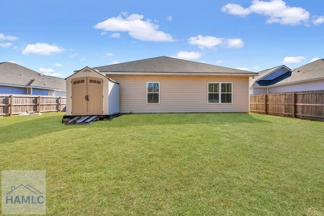 back of house with a yard and a storage unit