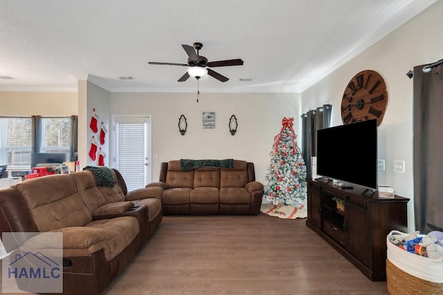 living room with hardwood / wood-style floors, ceiling fan, and ornamental molding