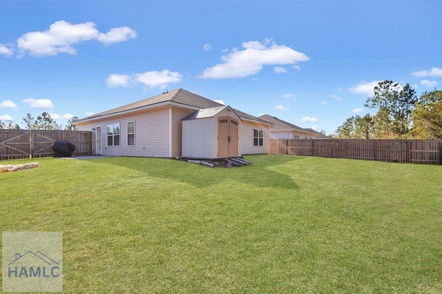 back of house featuring a lawn and a shed