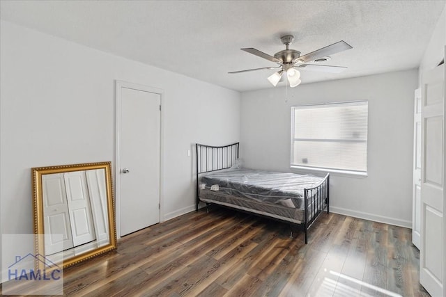 bedroom featuring ceiling fan and dark hardwood / wood-style floors