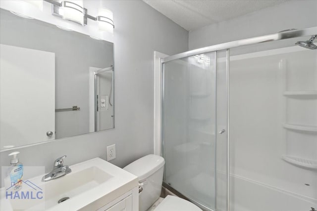 bathroom with vanity, toilet, and an enclosed shower