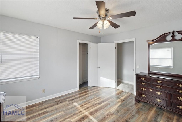 unfurnished bedroom featuring hardwood / wood-style flooring and ceiling fan