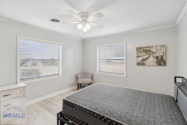 bedroom featuring ceiling fan, ornamental molding, and light hardwood / wood-style flooring