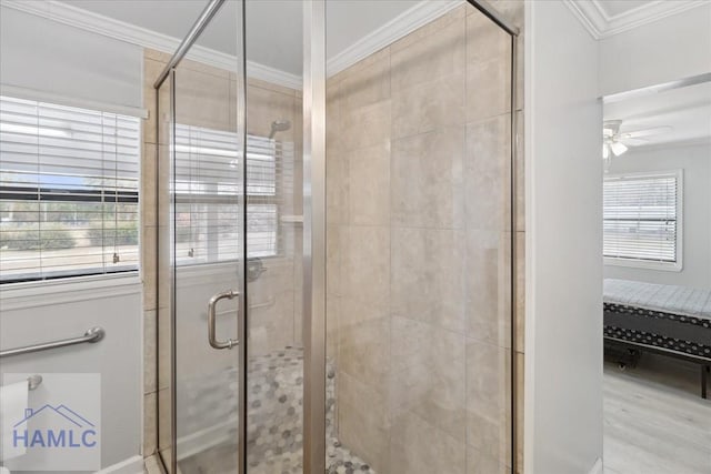 bathroom with ceiling fan, ornamental molding, and walk in shower