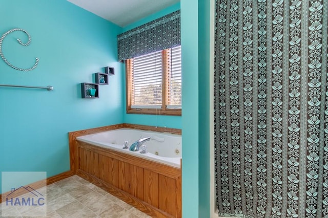 bathroom with a jetted tub and tile patterned flooring