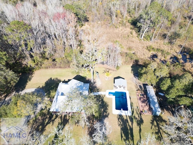 birds eye view of property featuring a view of trees