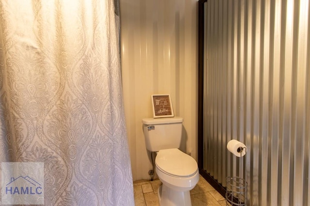 bathroom featuring toilet and tile patterned floors