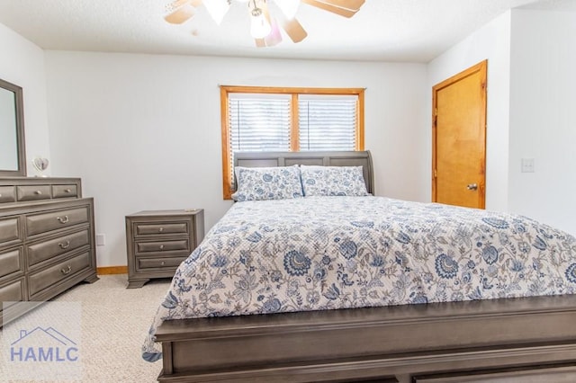 bedroom with a ceiling fan and light colored carpet