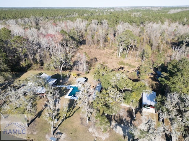 bird's eye view featuring a wooded view