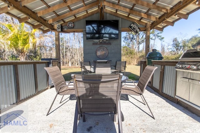 view of patio / terrace featuring grilling area, outdoor dining area, and exterior kitchen