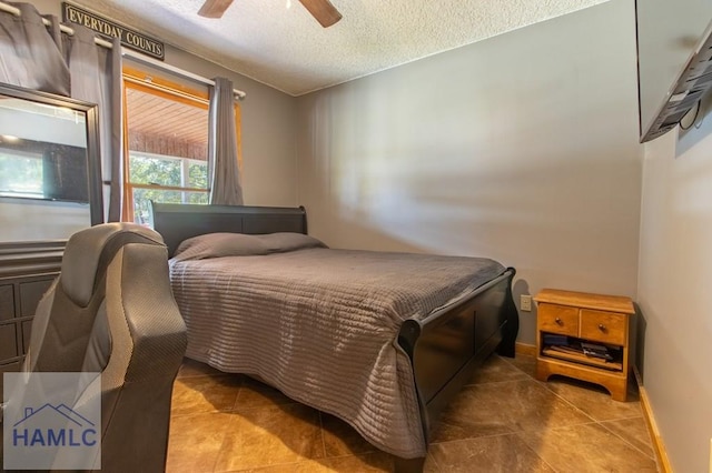 bedroom with baseboards, a ceiling fan, and a textured ceiling