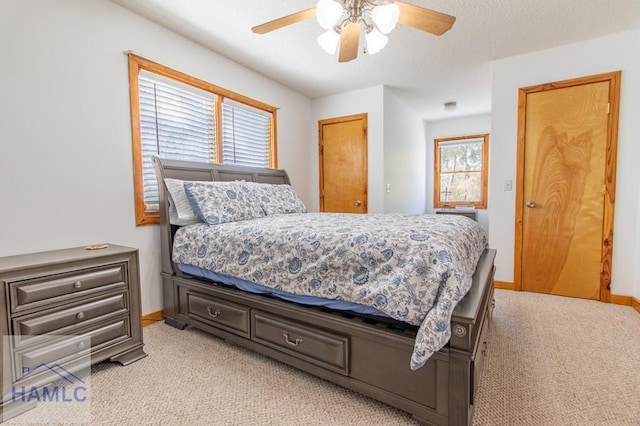 bedroom featuring light carpet, ceiling fan, and baseboards