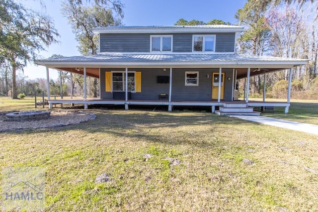 farmhouse inspired home with metal roof, a porch, and a front yard