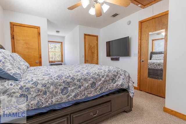 bedroom featuring baseboards, ceiling fan, visible vents, and attic access