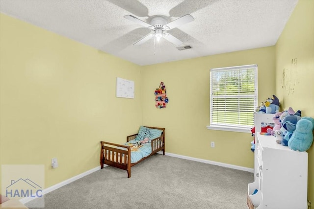 1325 Loblolly Dr, Hinesville, GA 31313 - bedroom with a textured ceiling, carpet, and ceiling fan