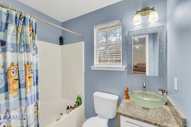 1325 Loblolly Dr, Hinesville, GA 31313 - full bathroom featuring shower / bath combo with shower curtain, vanity, and a textured ceiling
