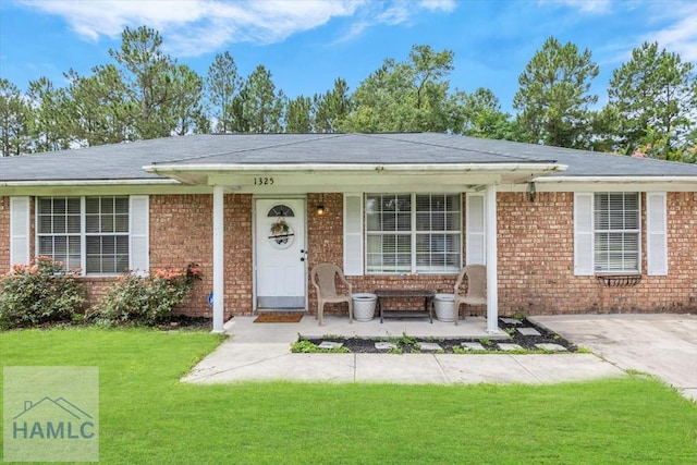 1325 Loblolly Dr, Hinesville, GA 31313 - ranch-style house with a porch, a front lawn, brick siding, and roof with shingles