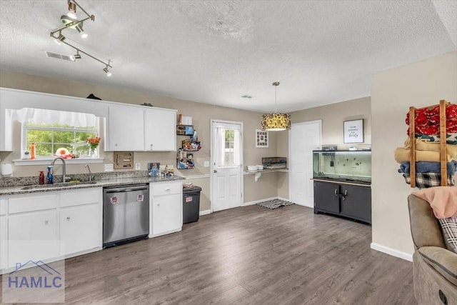 1325 Loblolly Dr, Hinesville, GA 31313 - kitchen featuring stainless steel dishwasher, a textured ceiling, white cabinets, wood finished floors, and plenty of natural light