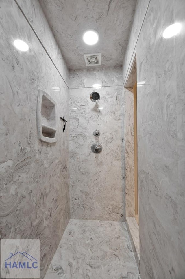 bathroom with a tile shower