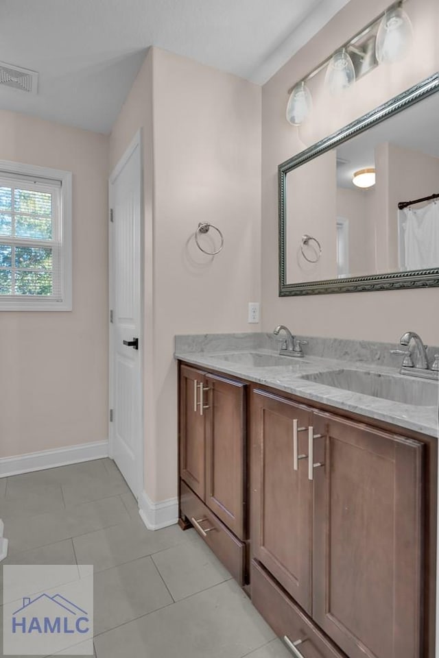 bathroom featuring tile patterned flooring and vanity