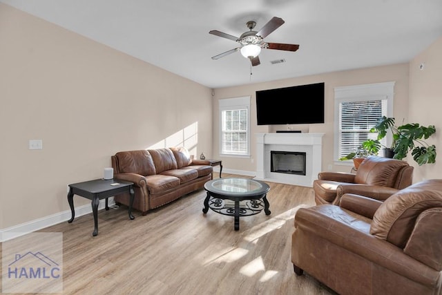 living room with ceiling fan and light wood-type flooring