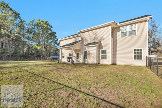 back of property featuring a lawn