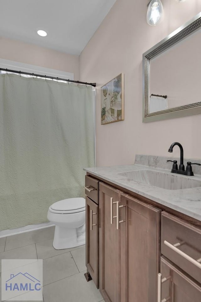 bathroom featuring tile patterned floors, vanity, and toilet