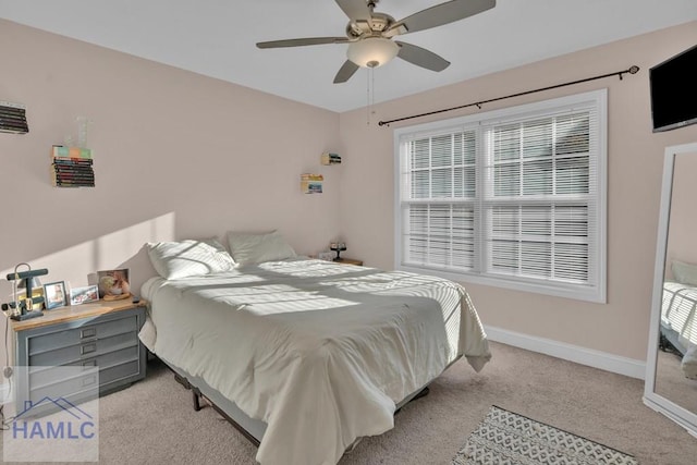 bedroom featuring ceiling fan and light carpet