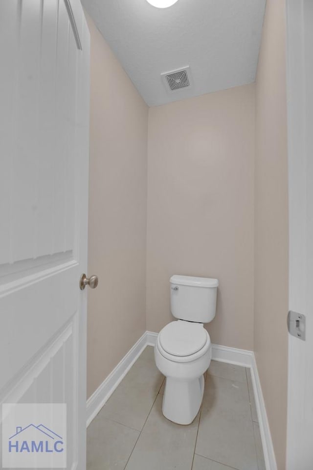 bathroom featuring tile patterned floors and toilet