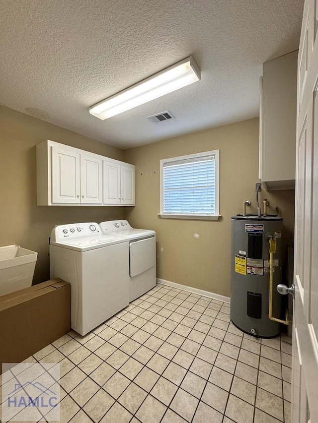 21 Forest Rd, Odum, GA 31555 - washroom with light tile patterned flooring, a textured ceiling, water heater, visible vents, and washer and clothes dryer