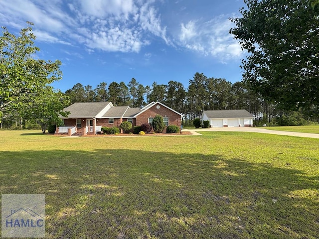 21 Forest Rd, Odum, GA 31555 - view of front of property featuring brick siding, a garage, an outbuilding, and a front yard