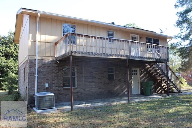 back of property featuring central AC unit, a patio area, a deck, and a yard