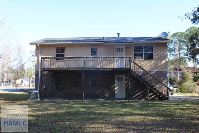 back of property featuring a lawn, a wooden deck, and central AC