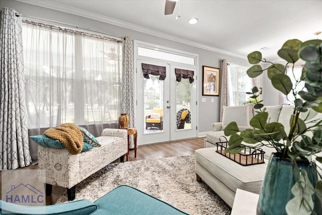 sitting room with crown molding, hardwood / wood-style floors, ceiling fan, and french doors